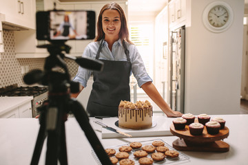 Woman recording vlog in kitchen