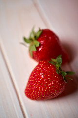 Close up of fresh juicy red strawberries on  white  table
