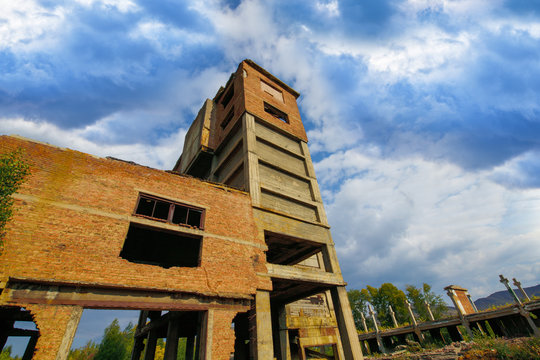 Karabash. Old ruined building, red brick factory, bottom view of blue sky. Horizontal photography