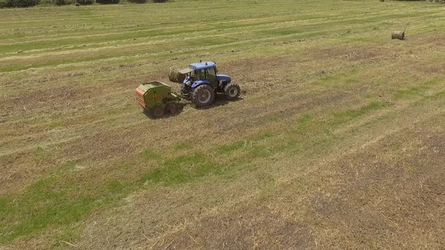 13bird eye of Man at work on the tractor with hay baler