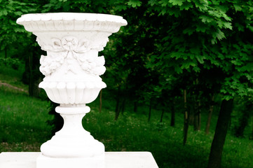 Antique decorative vase on the background of the city park