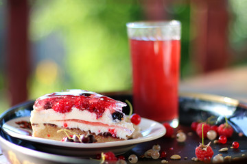 summer cake with berries with flowers and grass background