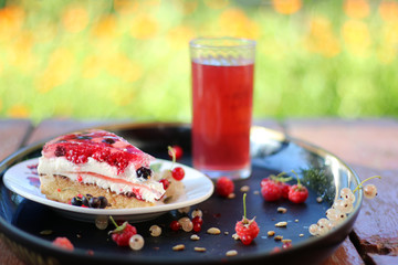 summer cake with berries with flowers and grass background