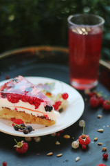 summer cake with berries with flowers and grass background