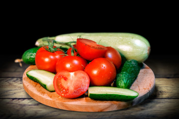 Vintage still life with vegetables on a board on an old wooden table