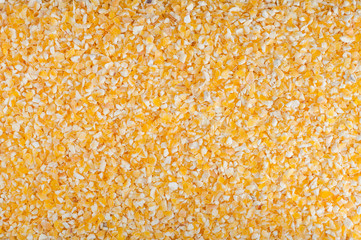 Grain of crushed dried corn yellow for cooking porridge.