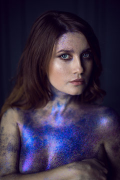 pregnant naked woman in glitter paint stands