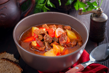 Traditional Hungarian goulash on the wooden table, horizontal
