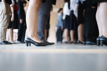Legs of business and woman waiting in a row