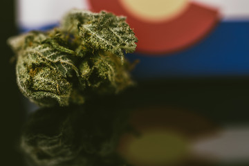 Medical Cannabis in Colorado - frosty strain with lots of resin in medical cannabis and flag of State Colorado.