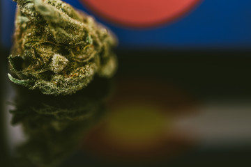 Medical Cannabis in Colorado - frosty strain with lots of resin in medical cannabis and flag of State Colorado.
