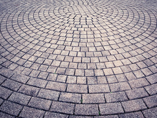 Urban paving arranged in concentric circles. Concentric circles texture. Toned image.