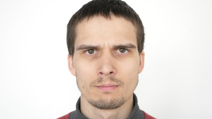 Obraz premium Angry man with evil eyes, serious dramatic expression. closeup on a white background