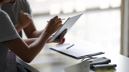 Doctor presenting a patient some information on a digital tablet