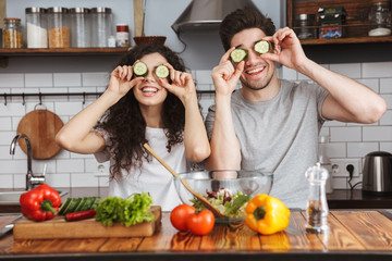 Cheerful couple cooking healthy fresh salad
