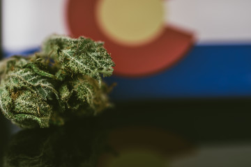 Medical Cannabis in Colorado - frosty strain with lots of resin in medical cannabis and flag of State Colorado.