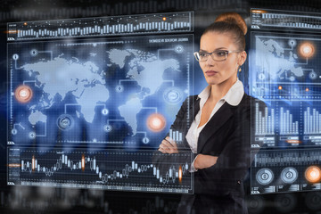 Young business lady works with virtual graphic interface in futuristic office