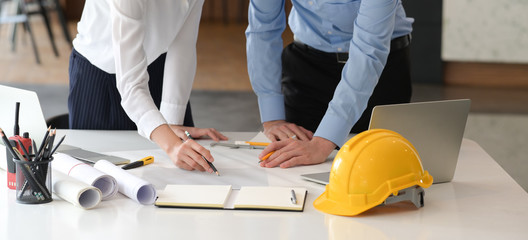 Designers colleagues discuss the sketches in office
