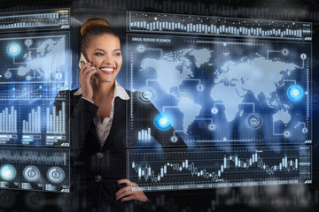 Young business lady speaks on the phone and works in futuristic office