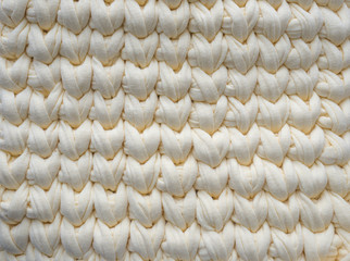 Closeup cotton light yellow knit blanket, warm and comfortable atmosphere. Knit background