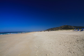 Fototapeta na wymiar Lonely wide beach in the morning during low tide - Zahara delos Atunes at Costa de la Luz, Spain