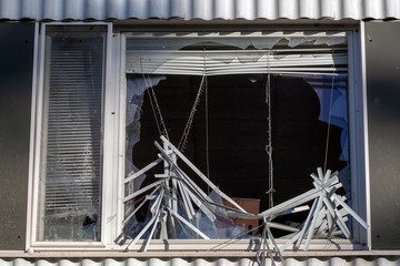 Fototapeta na wymiar broken window with Venetian blind