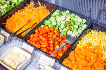 Colorful fresh vegetable salad bar with homemade sauces dressing