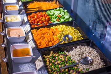 Colorful fresh vegetable salad bar with homemade sauces dressing