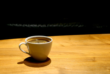 Cup of Hot Coffee Isolated on Wooden Table with Copy Space