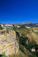 View on ancient village Ronda located precariously close to the edge of a cliff in Andalusia, Spain