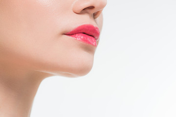 Fototapeta premium cropped view of young woman with pink lips isolated on white