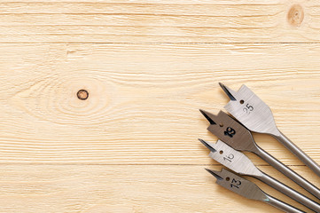 feather drill on wood on wooden background