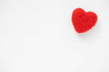 Obraz premium Red wool plush heart on white background