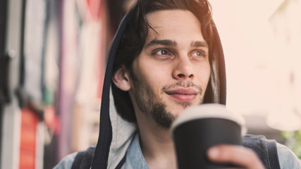 Young handsome man drinking coffee