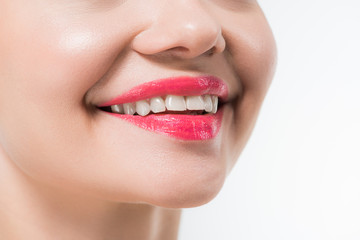 Fototapeta premium cropped view of young woman with pink lips smiling isolated on white