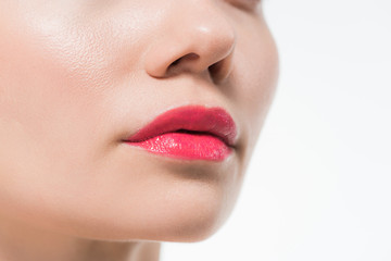 cropped view of woman with pink lips isolated on white