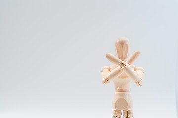 Refusal gesture, Wooden dummy, crossed hands on white background, copy space for your object or text