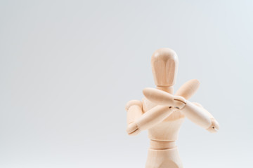 Refusal gesture, Wooden dummy, crossed hands on white background, copy space for your object or text