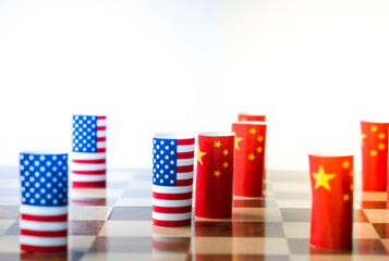 Fototapeta na wymiar USA flag and China flag on chess board for tariff trade war between United States and China who conflict because of both increase tax barrier of import and export product. Government and business.