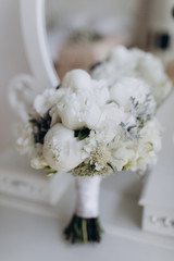 A wedding bouquet of roses. White roses on the grass.