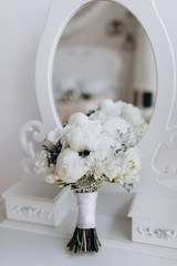 A wedding bouquet of roses. White roses on the grass.