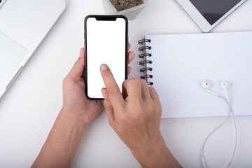 hand hold smartphone and touching on workspace table