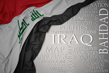 waving colorful national flag of iraq on a gray background with important words about country