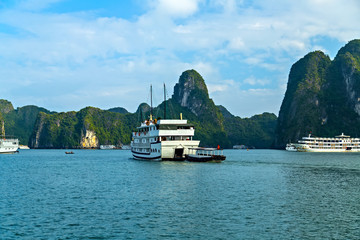 Cruise traditional ship wooden junk sailing Ha Long Bay, Vietnam UNESCO World Heritage Site.