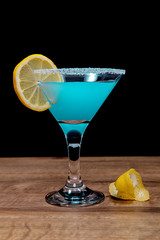 Blue alcoholic drink on black background