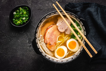 Japanese Ramen Soup with Udon Noodles, Pork, Eggs and Scallion on dark Stone Background - 267979655