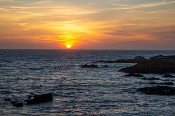 Fototapeta na wymiar Colorful sunset on the beach with rocks, at Porto, Portugal