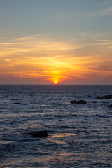 Fototapeta na wymiar Colorful sunset on the beach with rocks, at Porto, Portugal