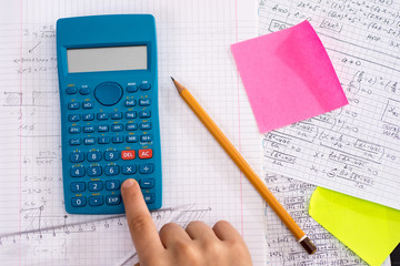 Scientific Calculator in the Action Hands During Mathematical Lesson. School Concept.