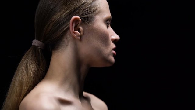 Woman taking off selfish tag from ear, self-confidence, protest against affront